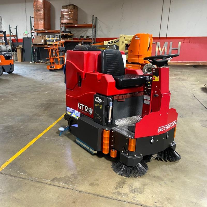 FactoryCat Ride On Floor Scrubbers GTR garage concrete - https://assets.factorycat.com/demoImages/2025/april/GTR-Ride On Floor Scrubbers-garage-concrete-Miami-USA-659.jpg - 800 - 800 - 659 GTR Ride On Floor Scrubber cleaning the concrete floor in a maintenance garage a a university in Miami, Florida