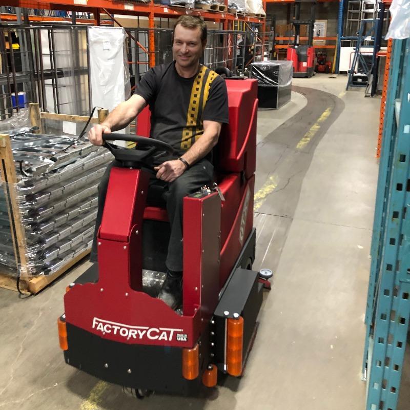 FactoryCat Ride On Floor Scrubbers GTX warehouse concrete - https://assets.factorycat.com/demoImages/2025/april/GTX-Ride On Floor Scrubbers-warehouse-concrete-Gary -USA-822.jpg - 800 - 800 - 822 A FactoryCat GTX Ride On Floor Scrubber cleaning the concrete warehouse of a Gary, Indiana fabrication shop