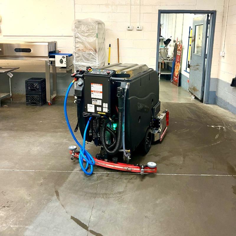 FactoryCat Walk Behind Floor Scrubbers Mag-HD kitchens concrete - https://assets.factorycat.com/demoImages/2025/april/Mag-HD-Walk Behind Floor Scrubbers-kitchens-concrete-Savanah-USA-900.jpg - 800 - 800 - 900 A FactoryCat Mag-HD Spec Ops walk behind floor scrubber cleaning the concrete floor of the kitchen at a Savanah, Georgia confectioner