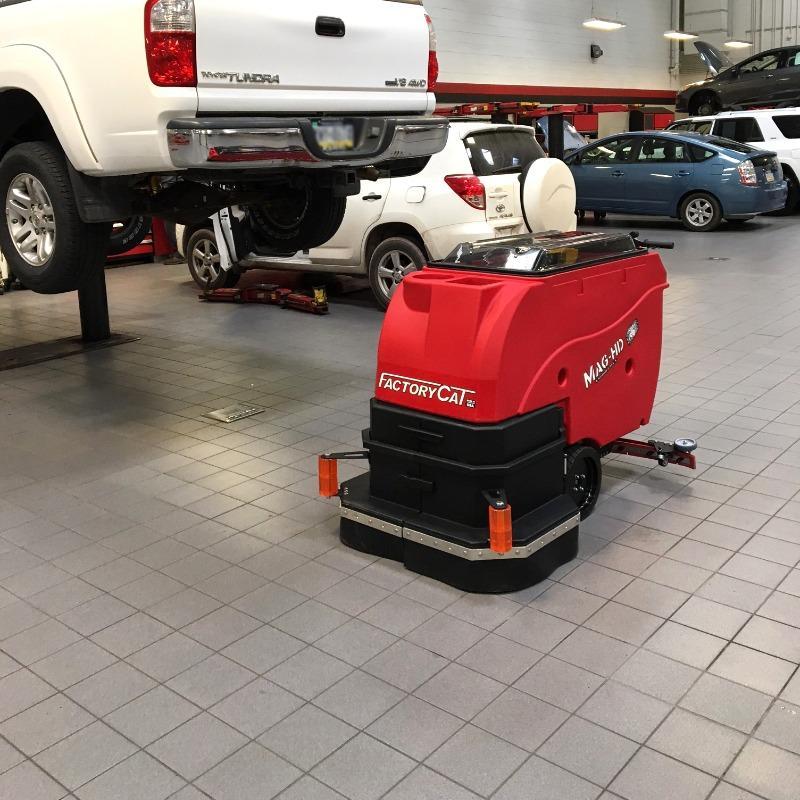 FactoryCat Walk Behind Floor Scrubbers Mag-HD service bay tile floors - https://assets.factorycat.com/demoImages/2025/april/Mag-HD-Walk Behind Floor Scrubbers-service bay-tile floors- Seaford-USA-864.jpg - 800 - 800 - 864 A FactoryCat Mag-HD Walk Behind Floor Scrubber cleans the tile floor in the service department of a Seaford, Delaware auto dealers