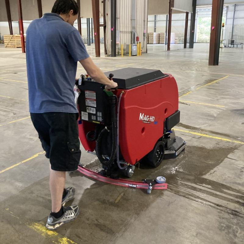 FactoryCat Walk Behind Floor Scrubbers Mag-HD warehouse concrete - https://assets.factorycat.com/demoImages/2025/april/Mag-HD-Walk Behind Floor Scrubbers-warehouse-concrete-Knoxville-USA-325.jpg - 800 - 800 - 325 A FactoryCat Mag-HD walk behind floor scrubber cleans the concrete floors in a warehouse outside Knoxville, Tennessee.