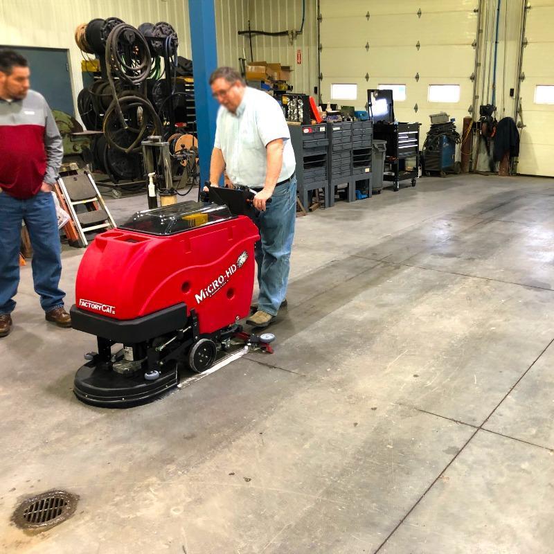 FactoryCat Walk Behind Floor Scrubbers Micro-HD service bay concrete - https://assets.factorycat.com/demoImages/2025/april/Micro-HD-Walk Behind Floor Scrubbers-service bay-concrete-Evansville-USA-943.jpg - 800 - 800 - 943 A FactoryCat Micro-HD walk behind floor scrubber cleans the concrete floors of a service bay at an Evansville, Indiana automobile repair shop