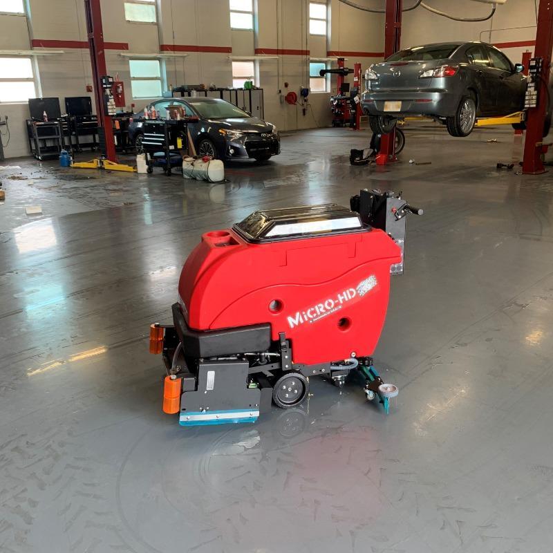 FactoryCat Walk Behind Floor Scrubbers Micro-HD service department concrete - https://assets.factorycat.com/demoImages/2025/april/Micro-HD-Walk Behind Floor Scrubbers-service department-concrete-Dayton-USA-936.jpg - 800 - 800 - 936 A FactoryCat Micro-HD walk behind floor scrubber cleaning the concrete floor of the service department of a Dayton, Ohio auto repair shop