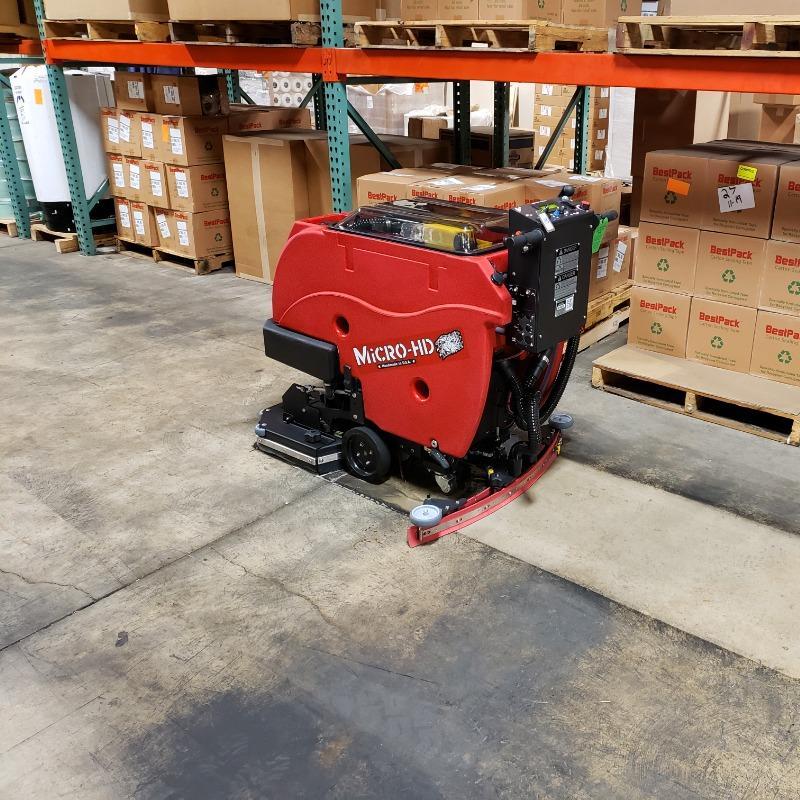 FactoryCat Walk Behind Floor Scrubbers Micro-HD warehouse concrete - https://assets.factorycat.com/demoImages/2025/april/Micro-HD-Walk Behind Floor Scrubbers-warehouse-concrete-Lodi-USA-947.jpg - 800 - 800 - 947 A FactoryCat Micro-HD walk behind floor scrubber cleans filthy concrete floors in the warehouse of a Lodi, Texas contract manufacturer