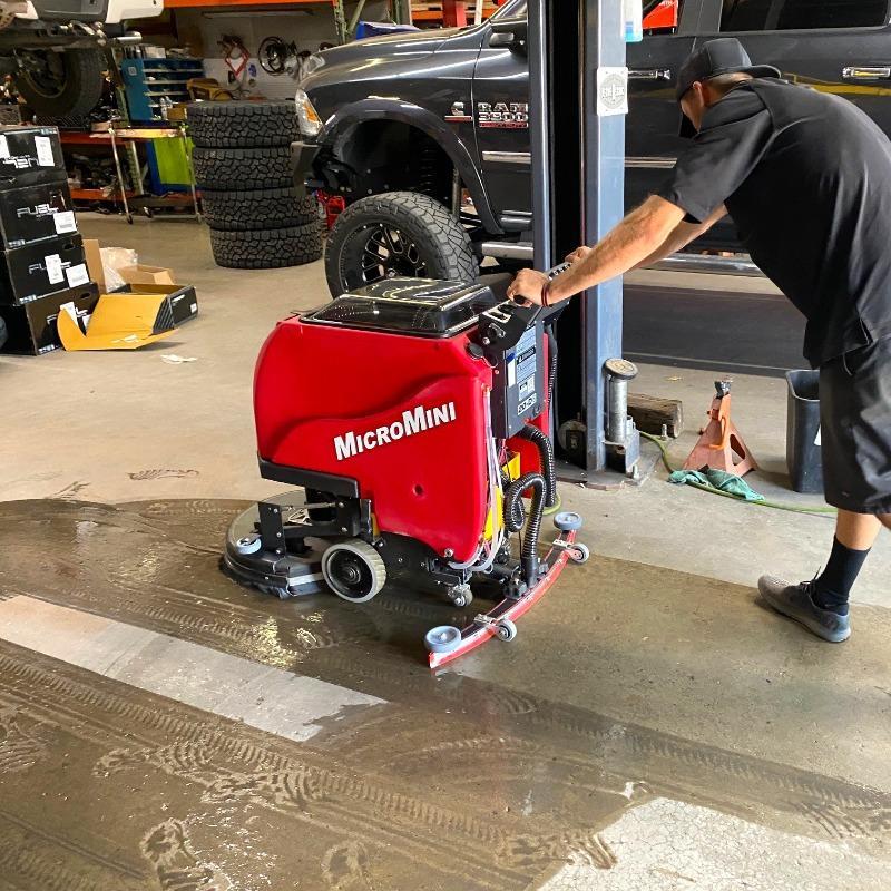 FactoryCat Walk Behind Floor Scrubbers MicroMini service bay concrete - https://assets.factorycat.com/demoImages/2025/april/MicroMini-Walk Behind Floor Scrubbers-service bay-concrete-Los Angeles-USA-306.jpg - 800 - 800 - 306 A MicroMag floor scrubber cleans a service bay of a an auto repair shop in in Los Angeles, CA.