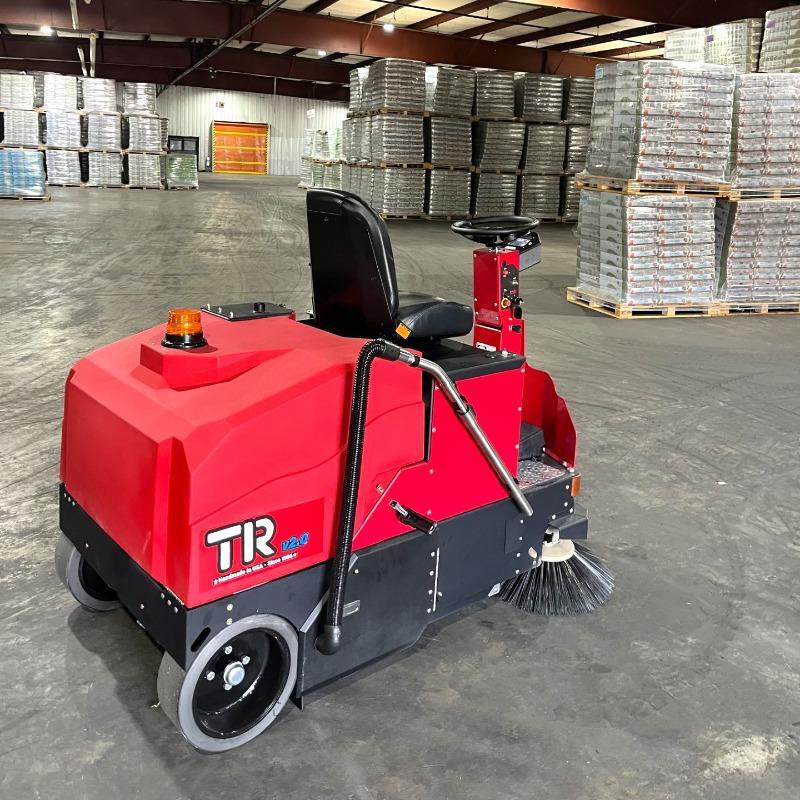 FactoryCat Ride On Floor Sweepers TR warehouse concrete - https://assets.factorycat.com/demoImages/2025/april/TR-Ride On Floor Sweepers-warehouse-concrete-Norfolk-USA-435.jpg - 800 - 800 - 435 A FactoryCat TR battery floor sweeper cleaning the concrete floor at a pet supply warehouse in Norfolk, VA